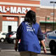Walmart employee Anna Hines walks through the parking lot of the soon-to-opened Walmart in Chicago on Sept. 21, 2006. (Tim Boyle/Getty Images)